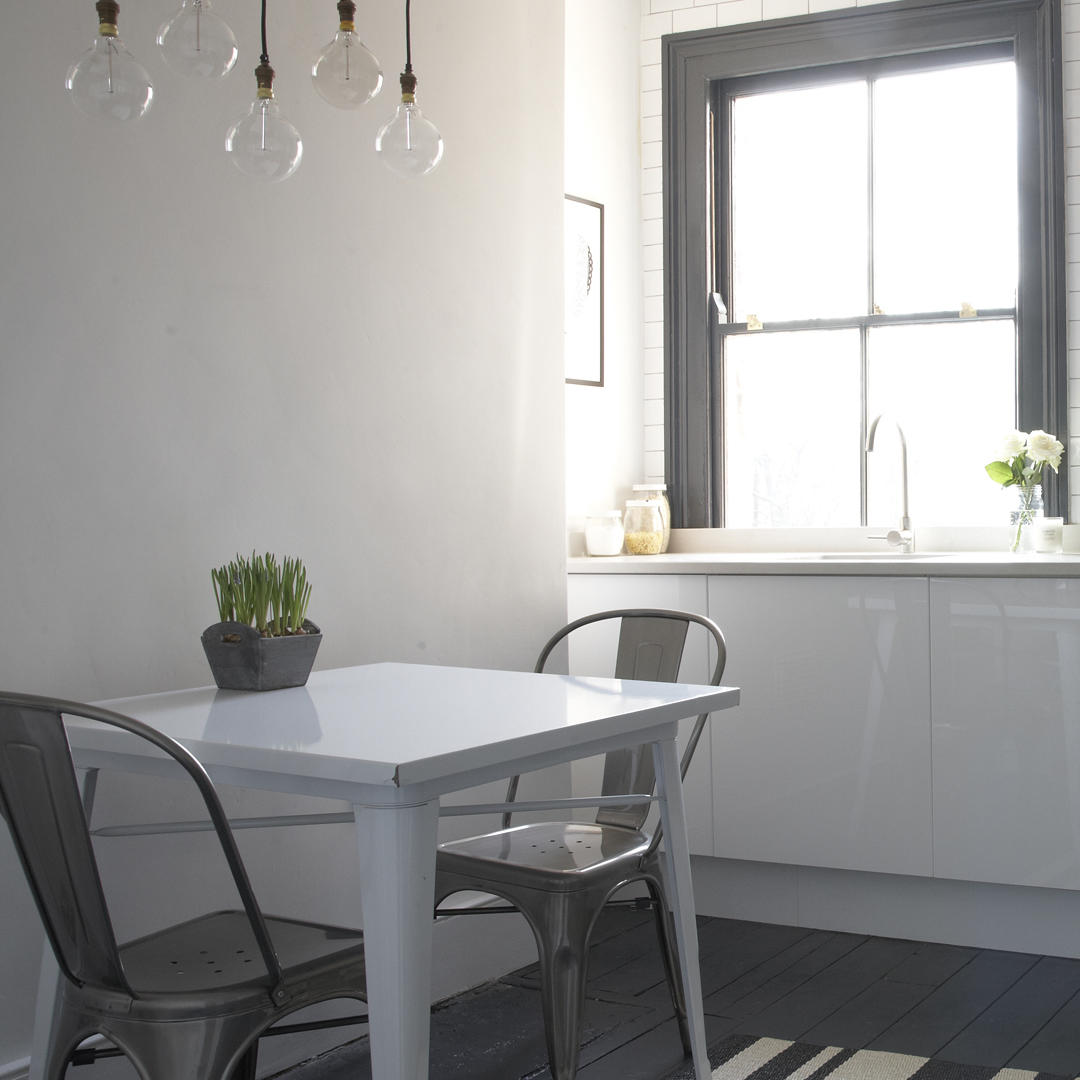 Small dining room with overhead bare bulb pendants