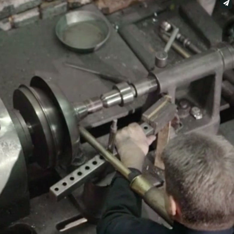 A steel light shade being made