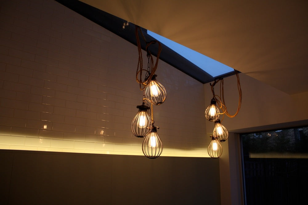 Highbury House extension lit by filament bulbs with bulb guards