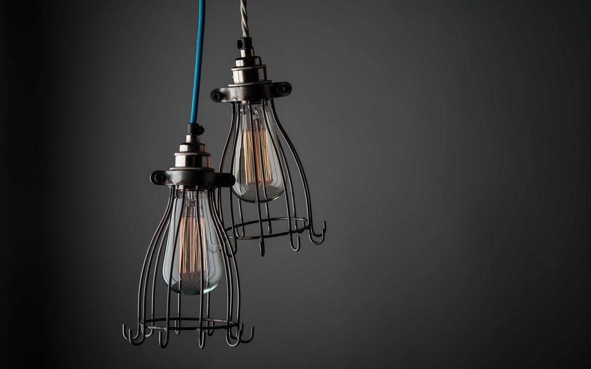 Dimmed filaments with open cage pendants