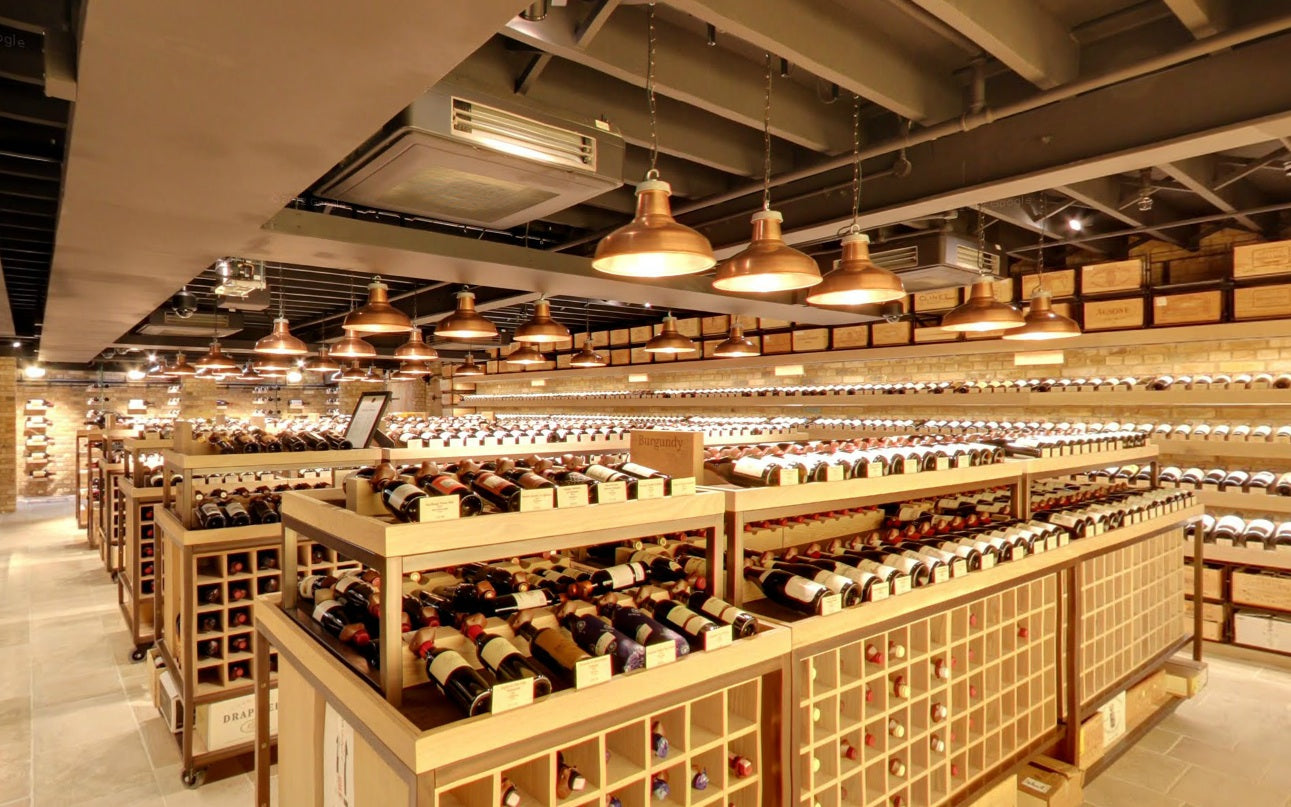 The central wine displays lit by rows of copper reflectors.