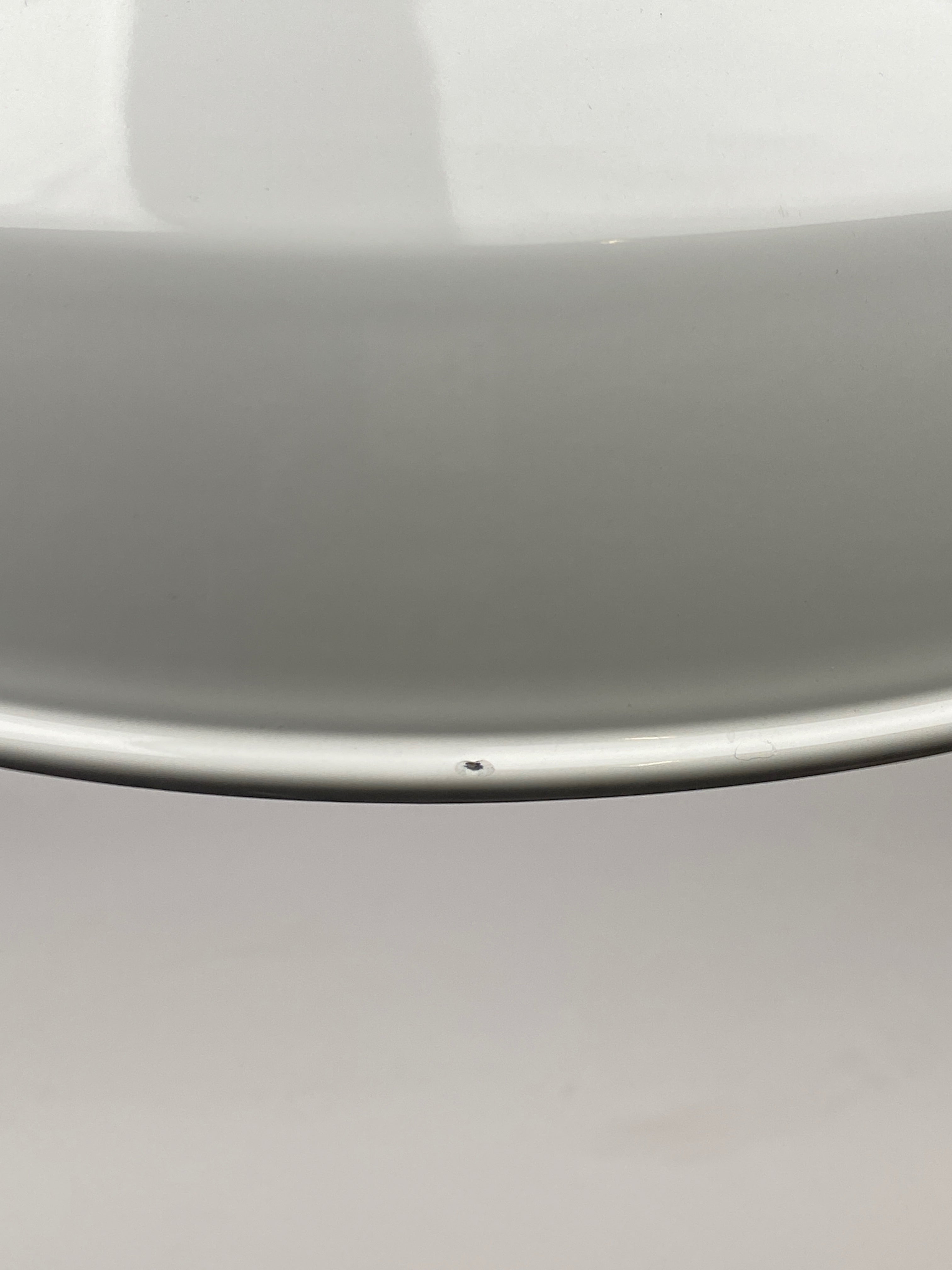 Example of Grade B damage that may be visible on a Worn Lighting Shade. Image shows minor chips to the rim of a white shade.